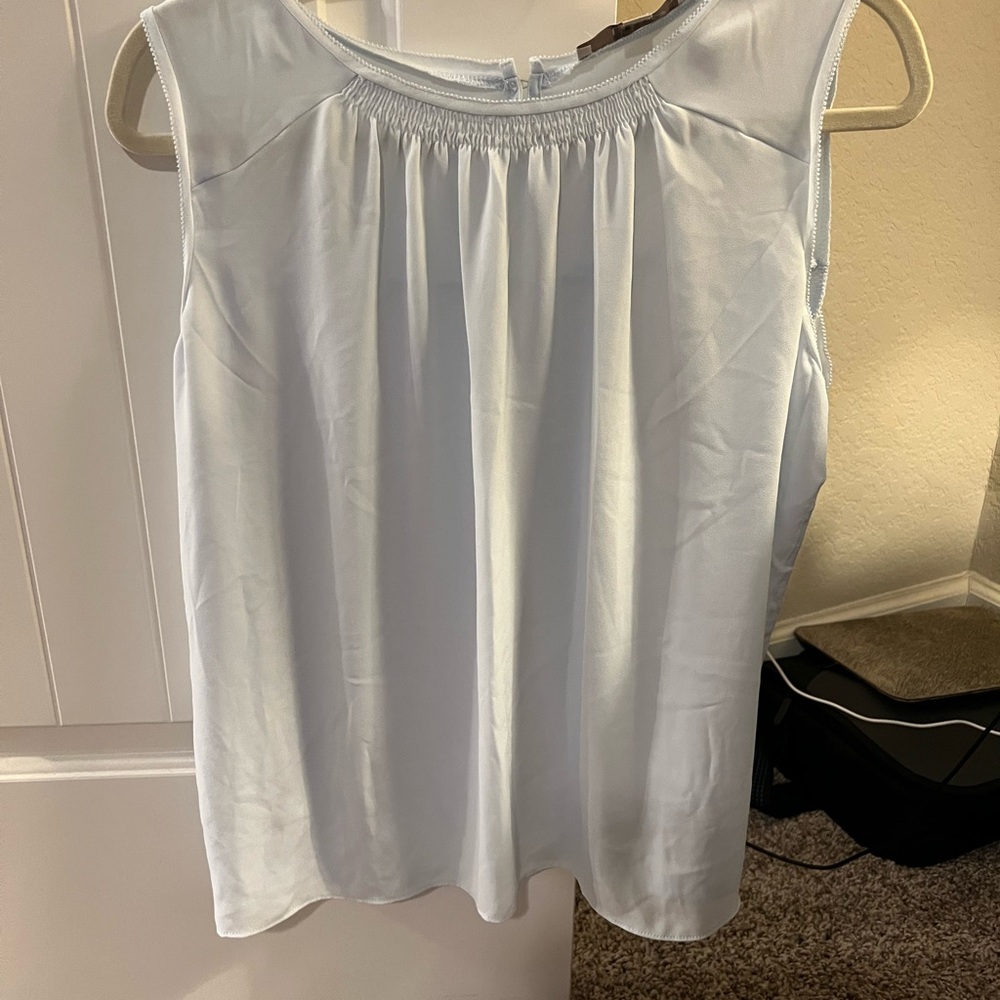 Really cute light blue sleeveless shirt!  Looks great under a blazer.
